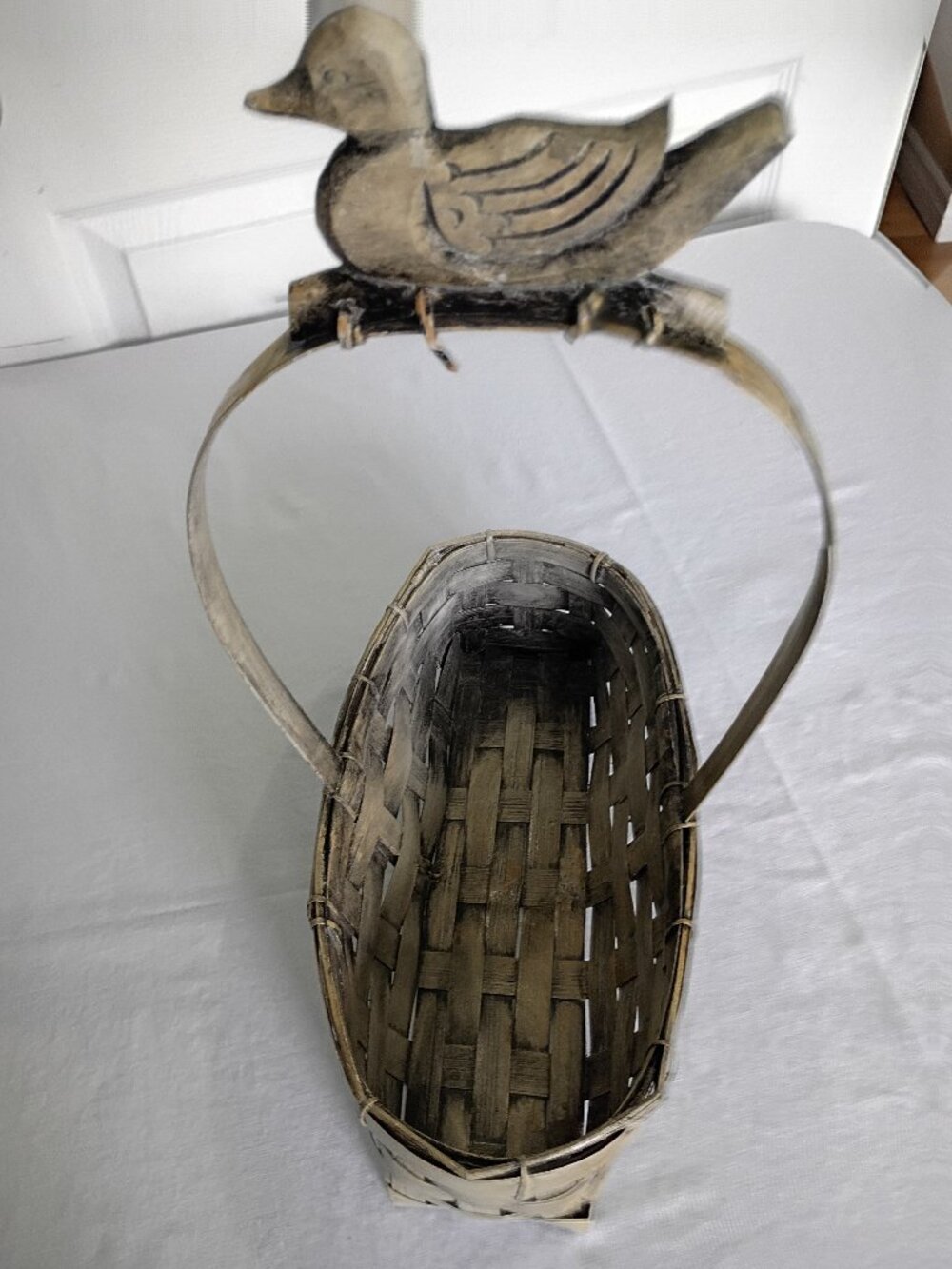 Rustic Woven Basket with Decorative Wooden Duck